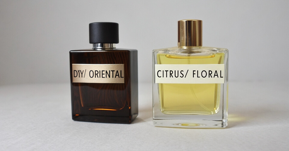 Two perfume bottles representing different fragrance families. One is dark and woody, labeled 