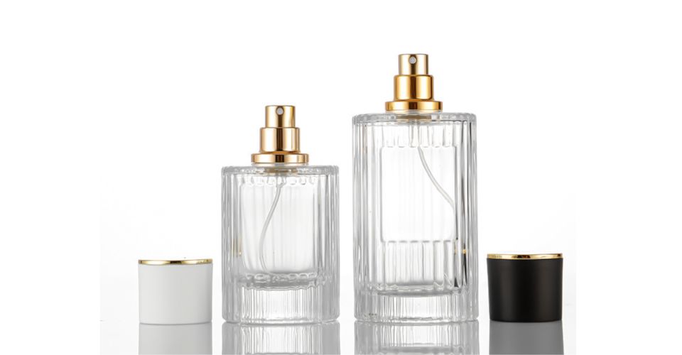 A detailed close-up shot of a person unscrewing the atomizer from a perfume bottle, showing the threads of the classic screw-neck mechanism.