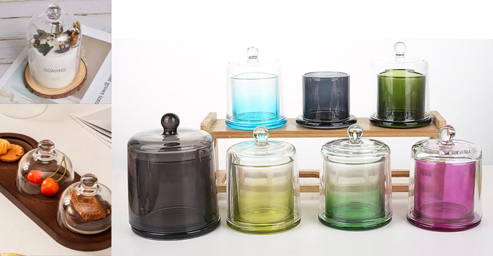 A lineup of five different glass candle cloches: one with a dark wood base, one with a gold metal base, one with a matching glass base, one with an antique-style etched pattern, and a simple minimalist cloche.