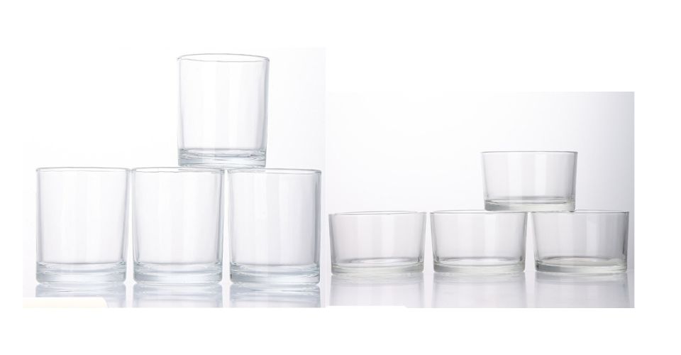 A classic clear glass straight-sided tumbler candle jar on a clean white background.