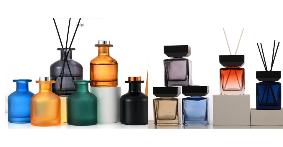 A lineup of high-quality glass reed diffuser bottles in various styles, including amber, matte black, clear, and frosted, on a clean background.